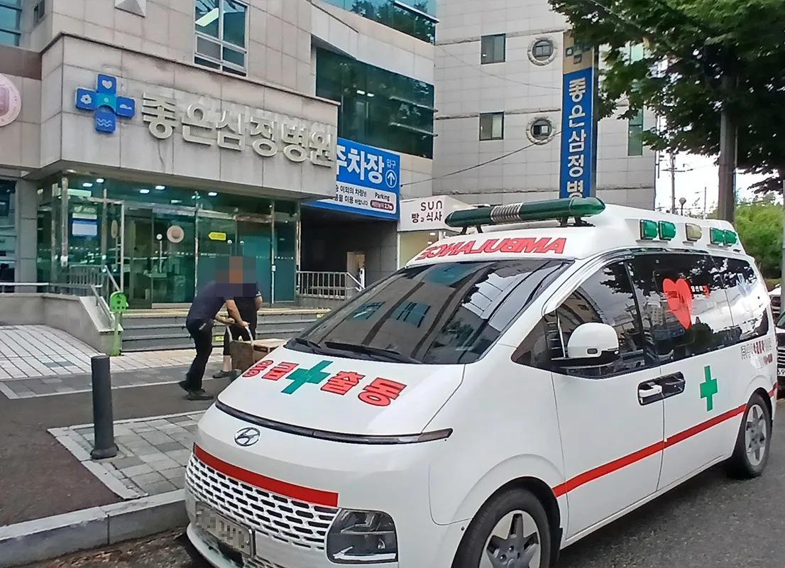좋은삼정병원 앞에서 짐을 옮기는 직원들과 중앙응급환자이송단 구급차